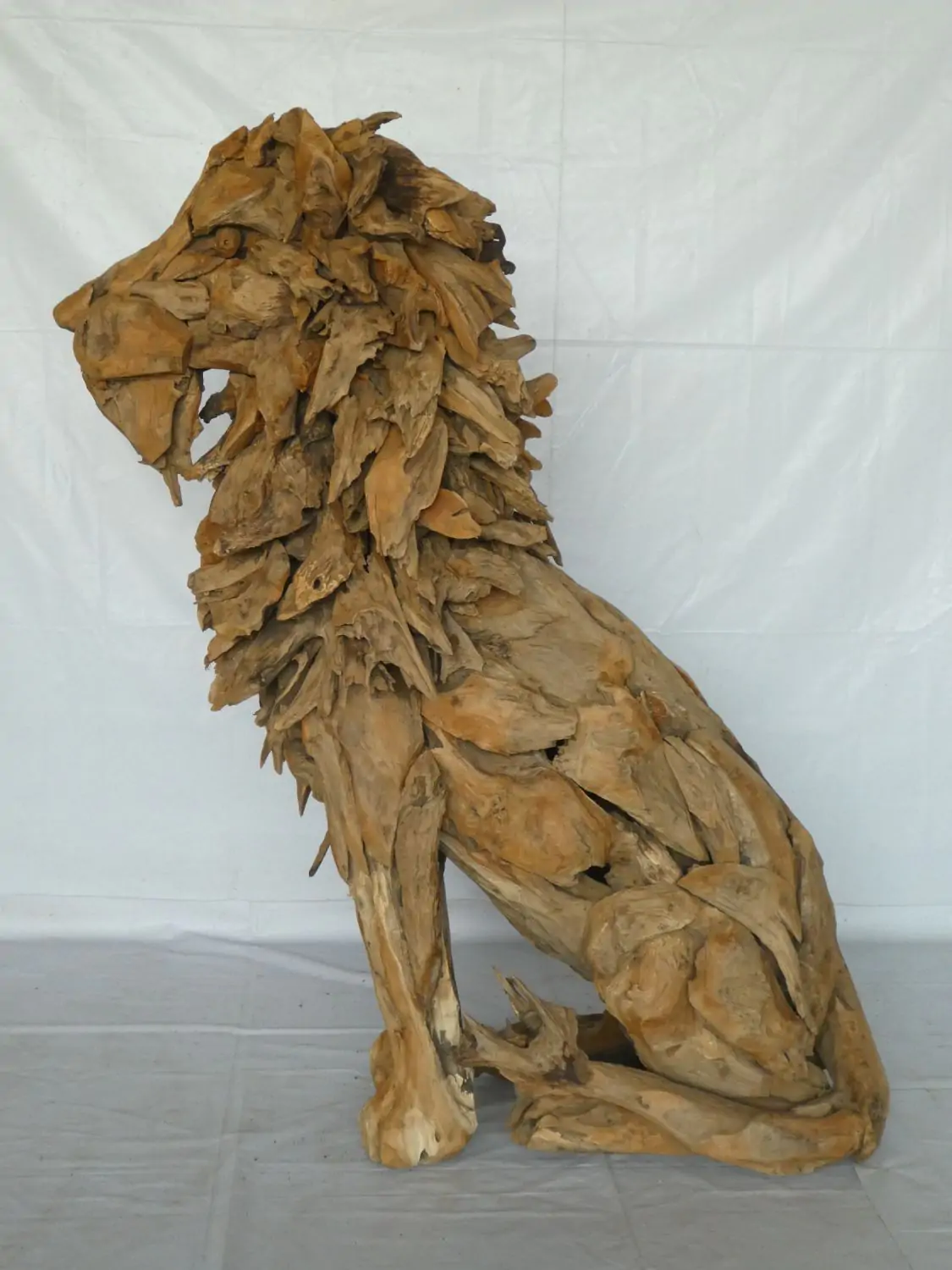  Product image 2 of the product “Seated royal Lion made from teak root pieces. About 100cm length and 150cm height. ”